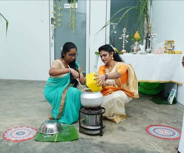 two women operating stove